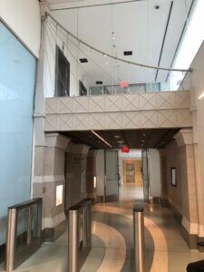 Photograph of the interior of NYU Hassenfeld Children's Hospital showing an elevator bank and mezzanine that resembles the Brooklyn Bridge